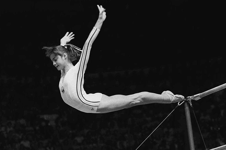 Nadia Comaneci dismounting from the parallel bars